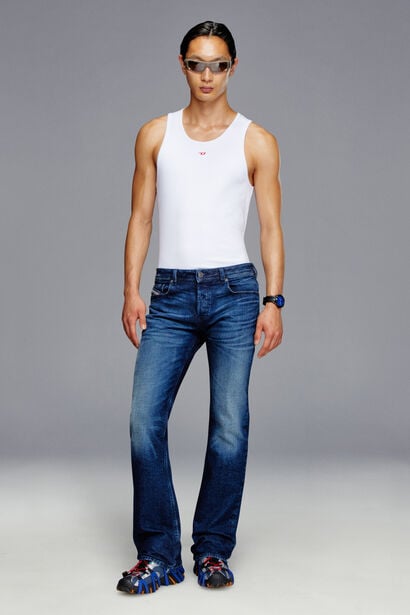 An elongated Bootcut fit with a mid-rise waist and low crotch. 